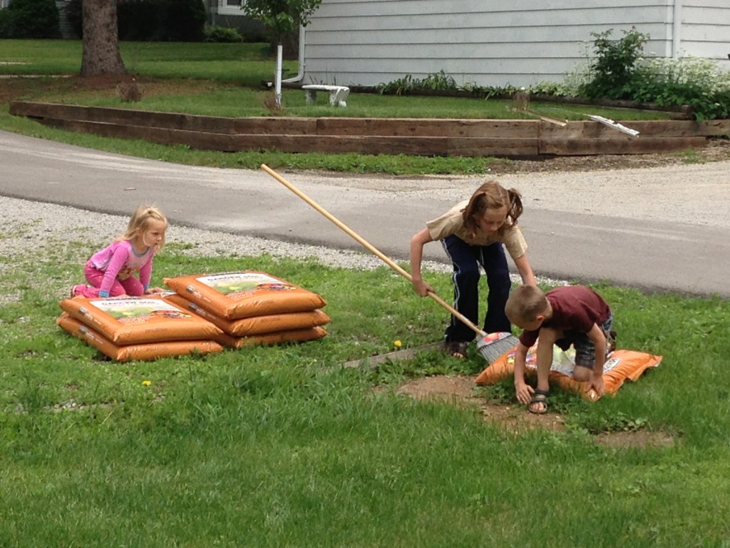 Kids helping their father with gardening.