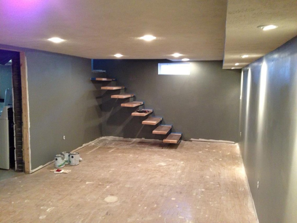 Finishing out the drywall by the floating stair base