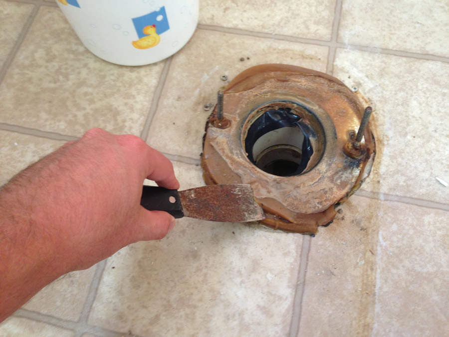 How to replace a wax toilet ring: Use a putty knife to remove the old wax toilet ring