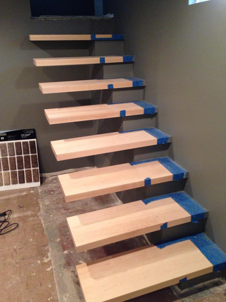 The walls get finishing touches, and the base of the floating stairs gets painted as well.